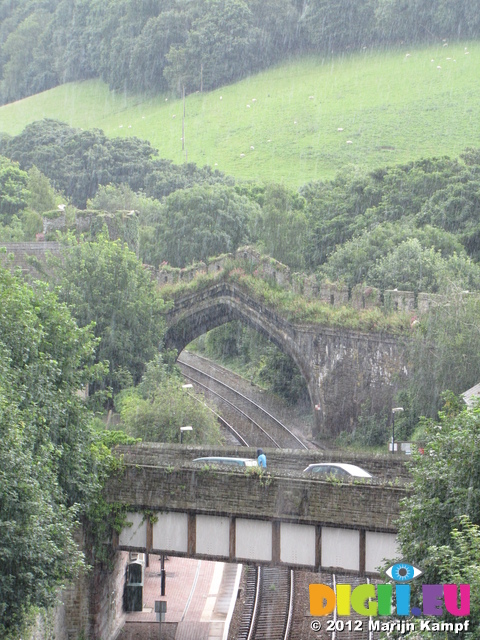 SX23432 Arch in medieval wall over railway in the rain